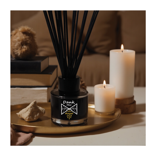 Vegan reed diffuser set displayed with lit candles and decorative accessories in a cozy setting.
