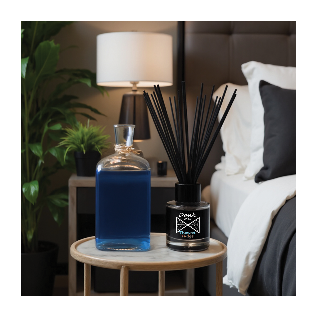 Thawed Fudge Single Diffuser displayed on a nightstand alongside a blue bottle, in a stylish bedroom setting.
