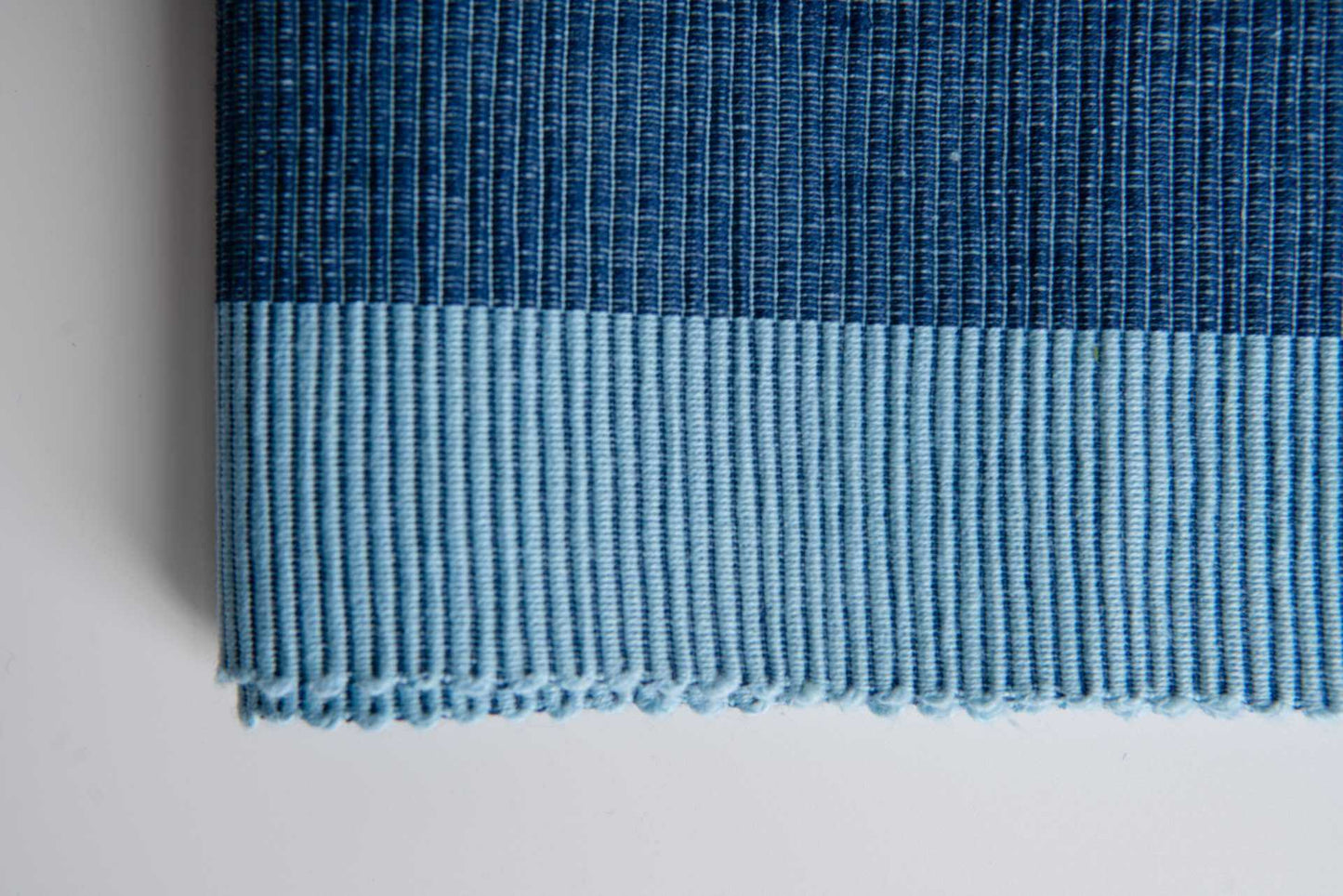 Luxury Placemats Blue - 4 Pack shown in a close-up of elegant fabric texture with navy and light blue colors.
