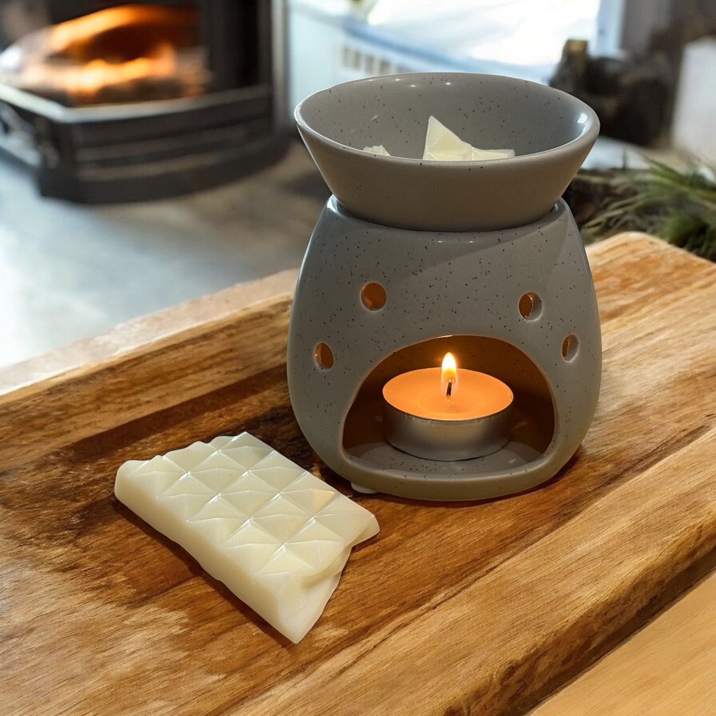 Orange & Bergamot Wax Melt Snap Bar 40g Luxury Soy Blend placed near a candle warmer on a wooden surface.