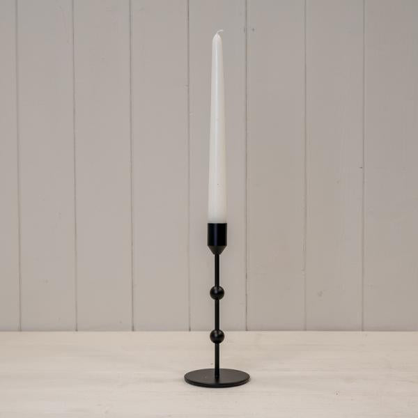 Medium Black Single Metal Candle Stick with white candle, adding elegance to any decor.