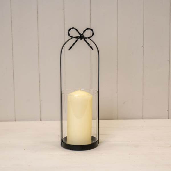 Medium Black Metal Candle Holder with Bow showcasing a decorative design for home decor.