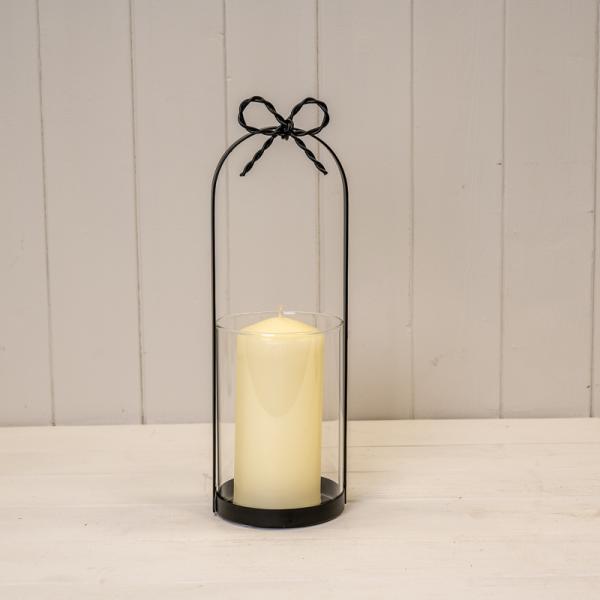 Medium Black Metal Candle Holder with Bow showcasing a decorative bow and cut-out design for a glowing ambience.