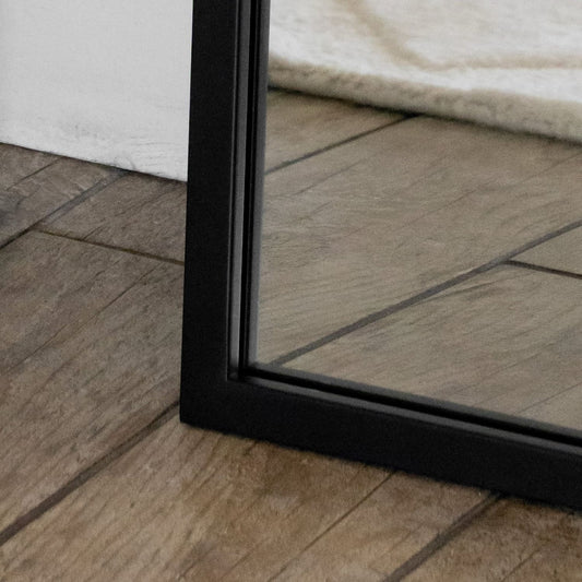 Close-up of the Yoko - Black Metal Gentle Arch Mirror - 120cm x 95cm showcasing the sleek black frame.