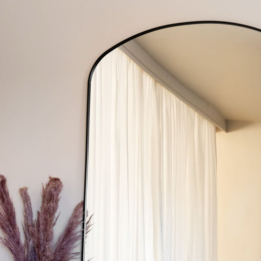 Yoko - Black Metal Gentle Arch Mirror - 180cm x 105cm reflecting light and elegance with soft drapes and decor.