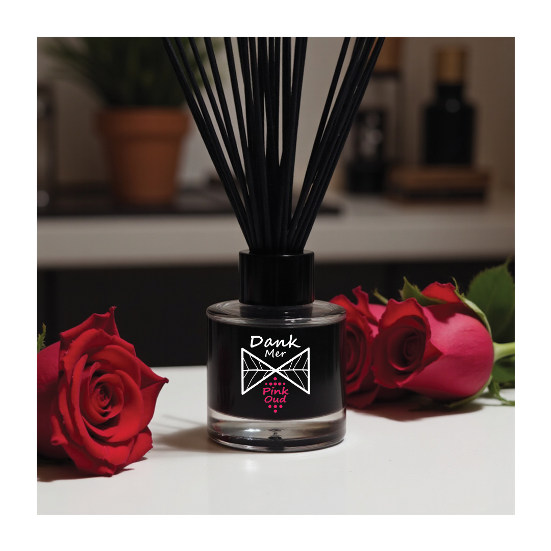 Vegan reed diffuser set displayed with roses, featuring a sleek design and long-lasting fragrance.