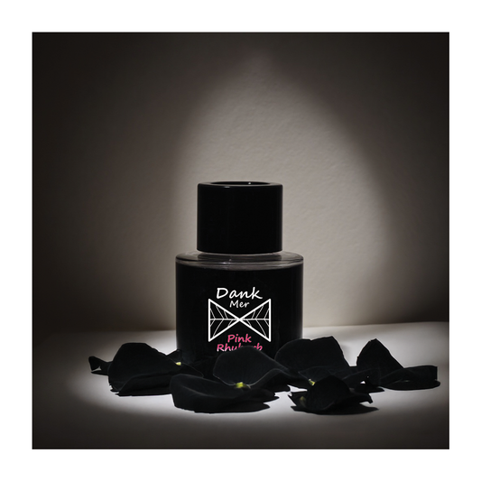 Pink Rhubarb Single Diffuser with black rose petals, elegantly lit to highlight its minimalist design.