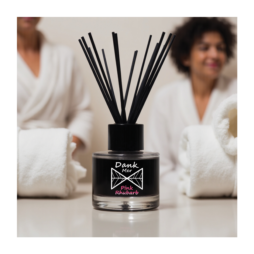 Pink Rhubarb Single Diffuser with black design and reeds, set against a cozy spa atmosphere.