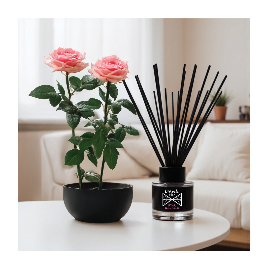 Pink Rhubarb Single Diffuser next to pink roses in a chic interior setting.