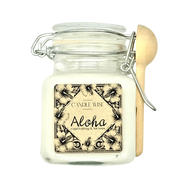 Aloha Scoopable Wax Melt in a glass jar with floral label and wooden scoop, captivating & luscious fragrance.