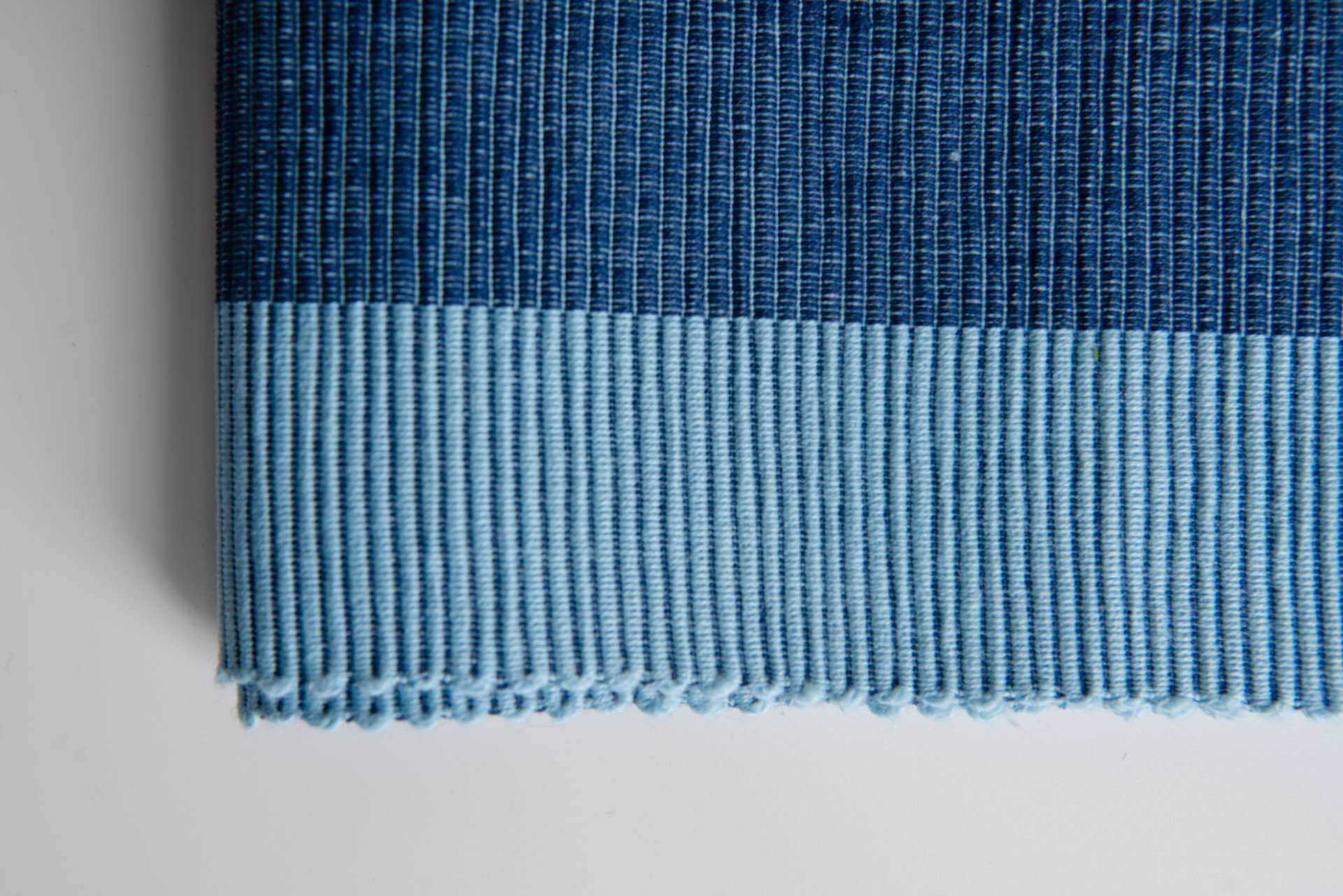 Luxury Placemats Blue - 4 Pack shown in a close-up of elegant fabric texture with navy and light blue colors.