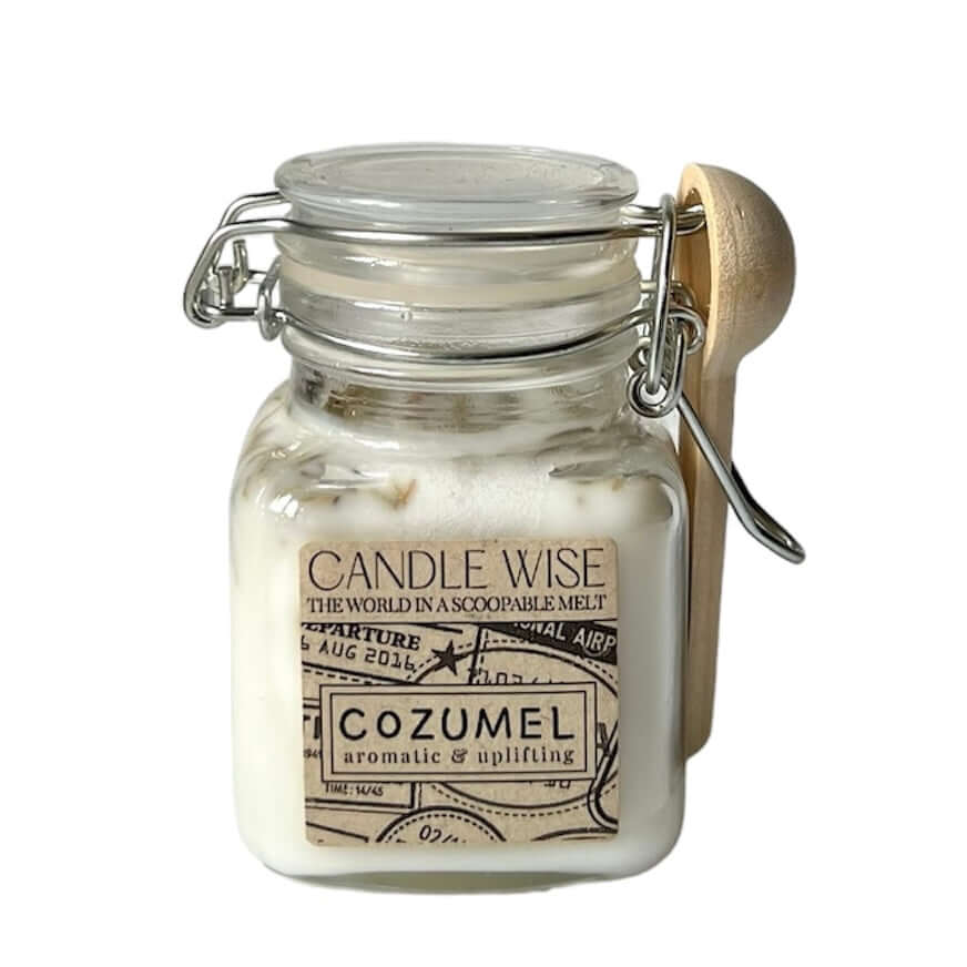 Cozumel Scoopable Wax Melt in a glass jar with a wooden spoon, capturing aromatic and uplifting scents.