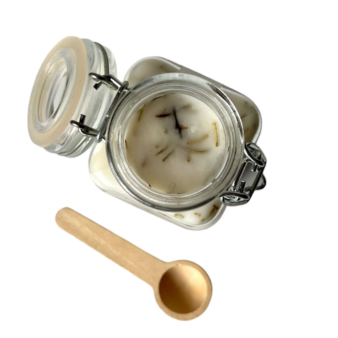 Cozumel Scoopable Wax Melt in a glass jar with a wooden scoop, featuring floral and tropical scents.