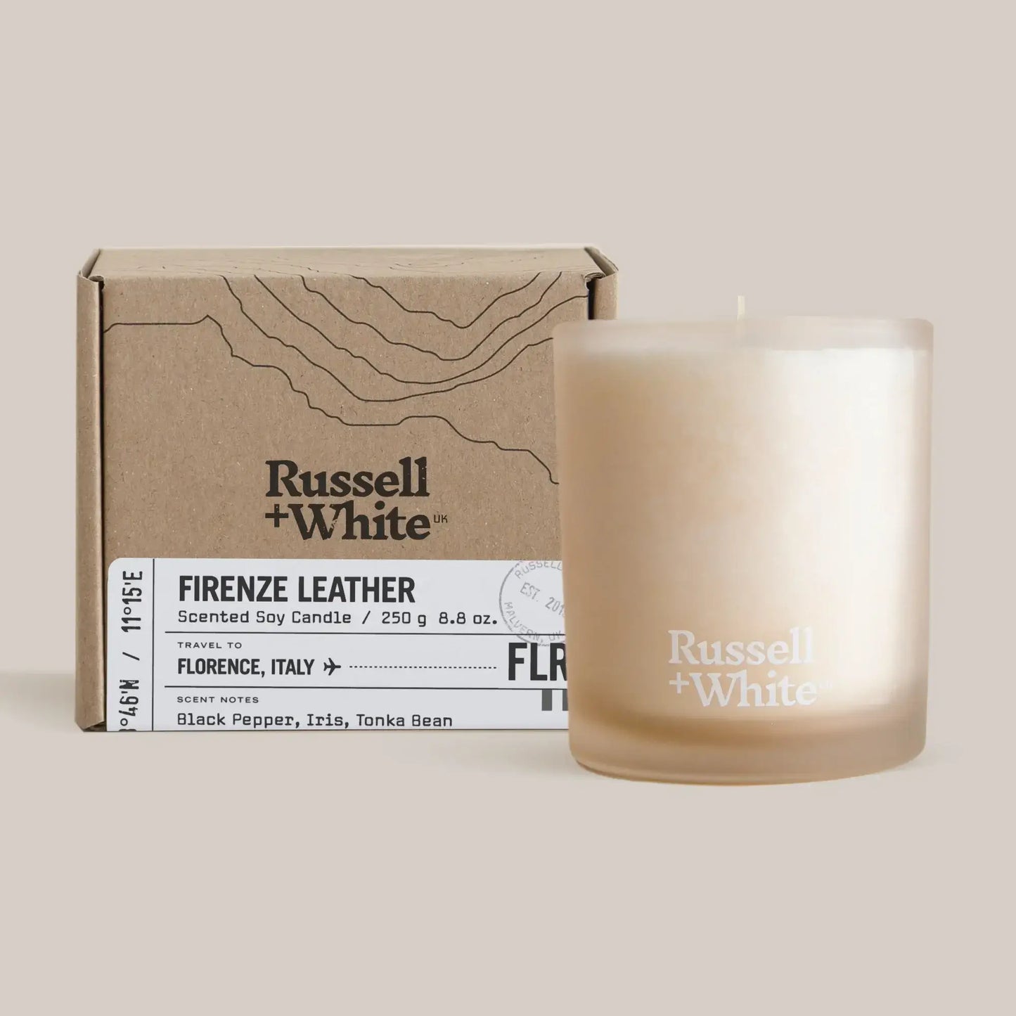 Firenze Leather Scented Candle by Russell + White with elegant packaging and creamy wax candle.