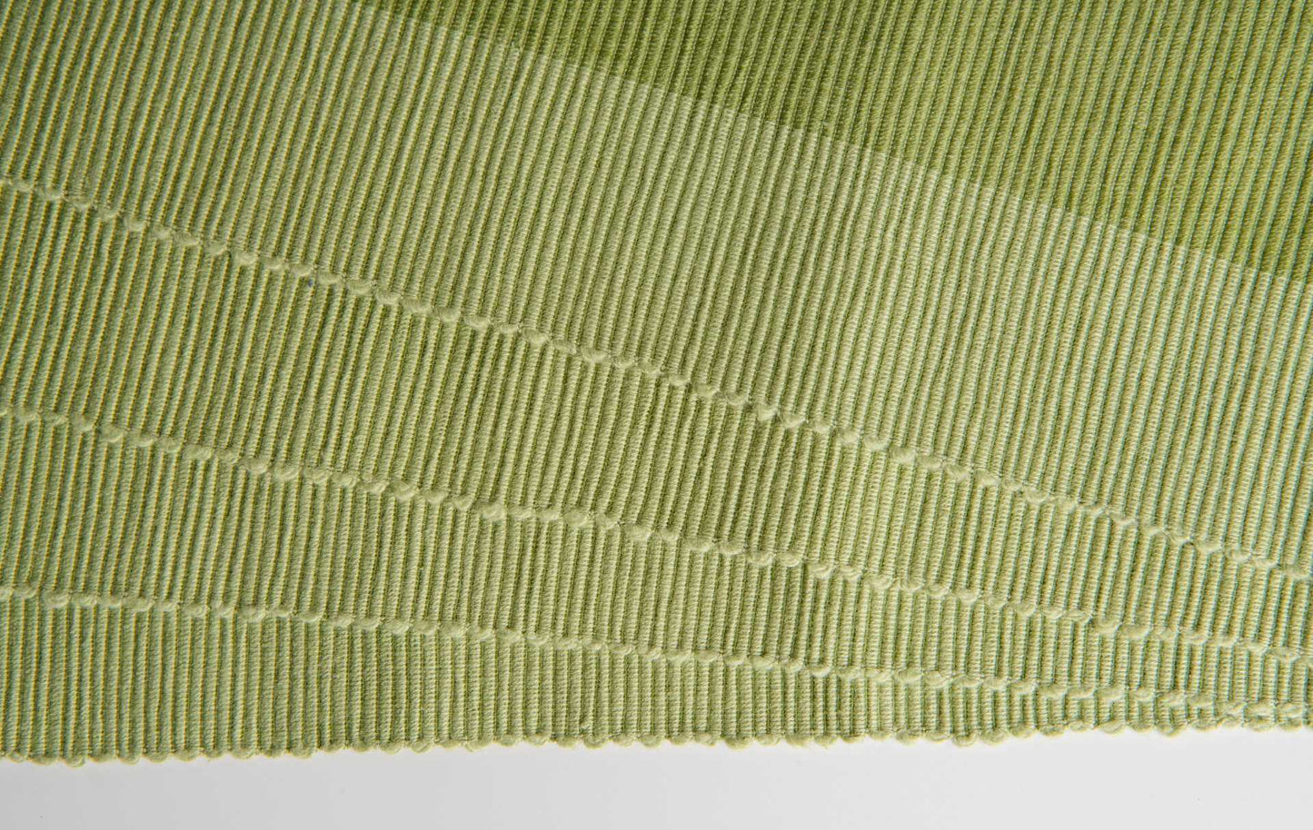 Luxury Placemats Green - 4 Pack showcasing the organic cotton texture and elegant weave design.