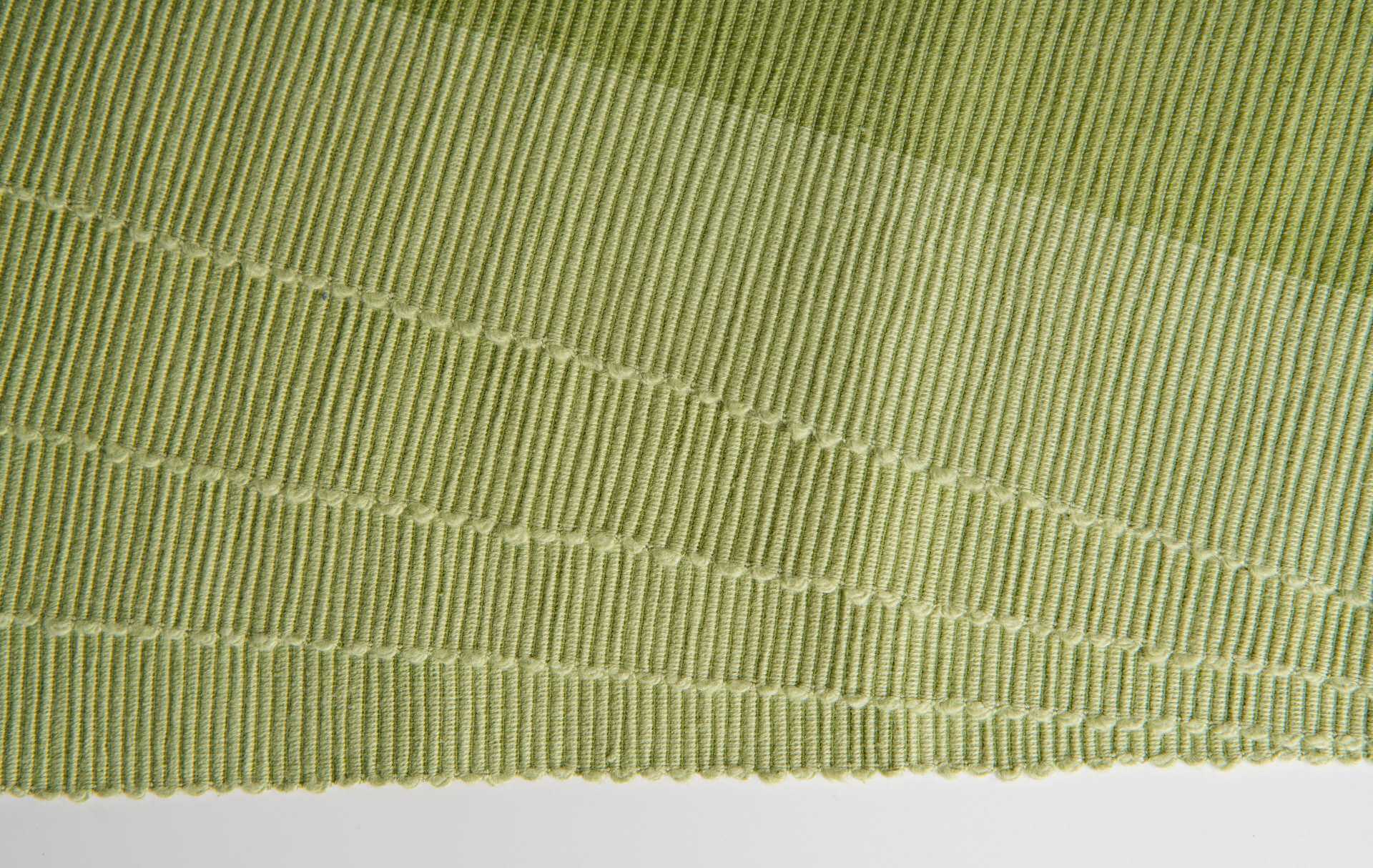 Luxury Placemats Green - 4 Pack showcasing the organic cotton texture and elegant weave design.