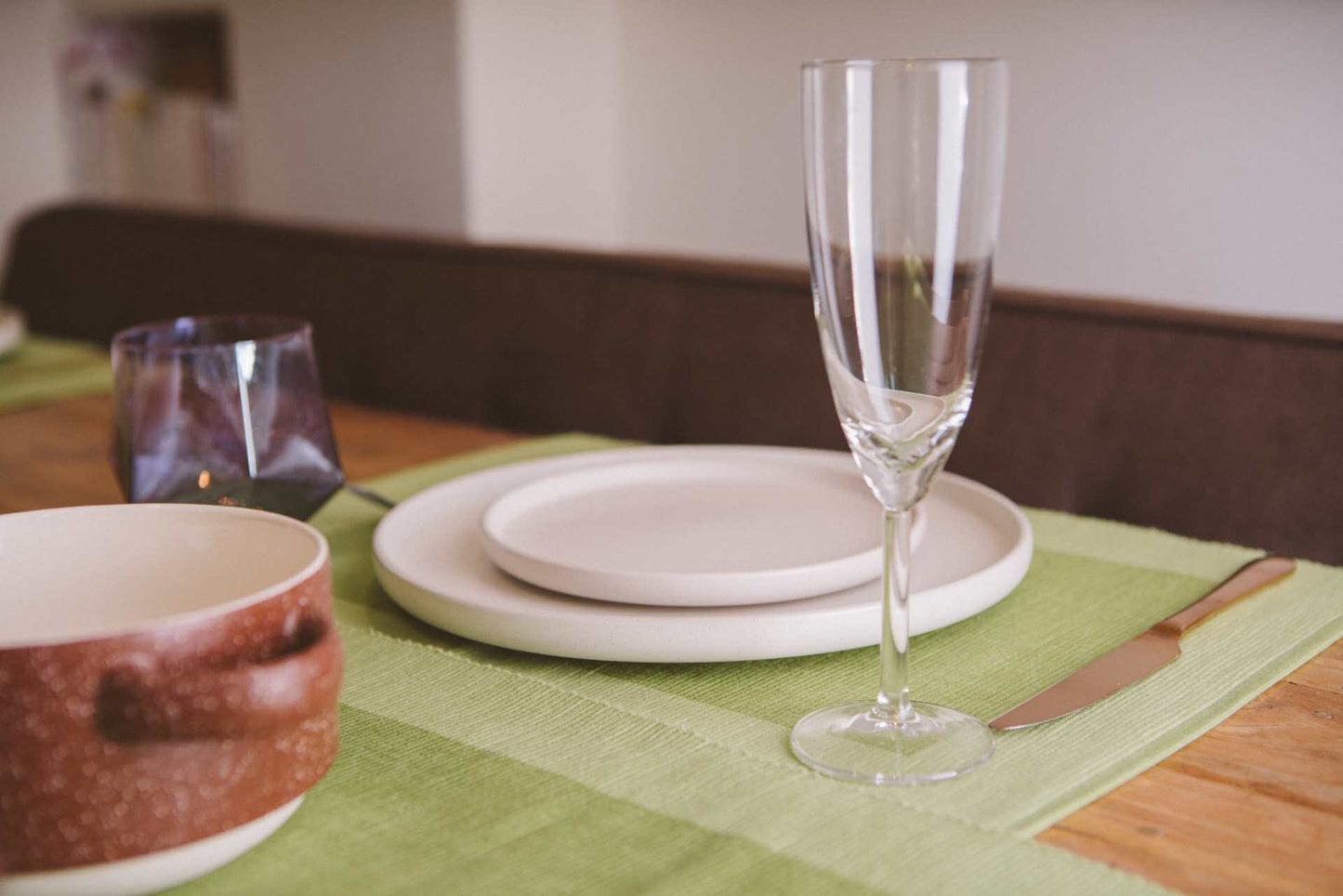 Luxury Placemats Green - 4 Pack displayed on a beautifully set dining table with elegant dishes and glassware.