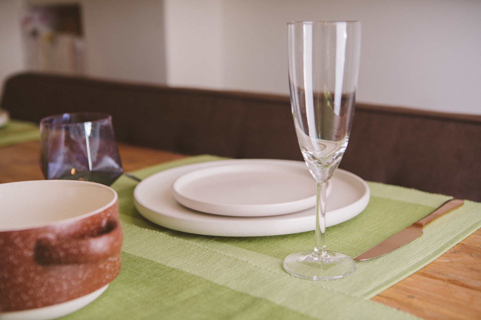 Luxury Placemats Green - 4 Pack displayed on a beautifully set dining table with elegant dishes and glassware.