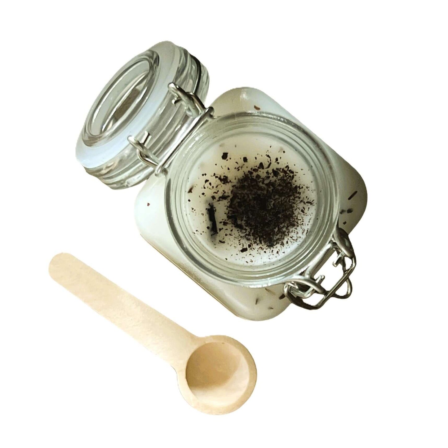 Kensington Scoopable Wax Melt in a glass jar with a wooden scoop, showcasing a luxury fragrance experience.
