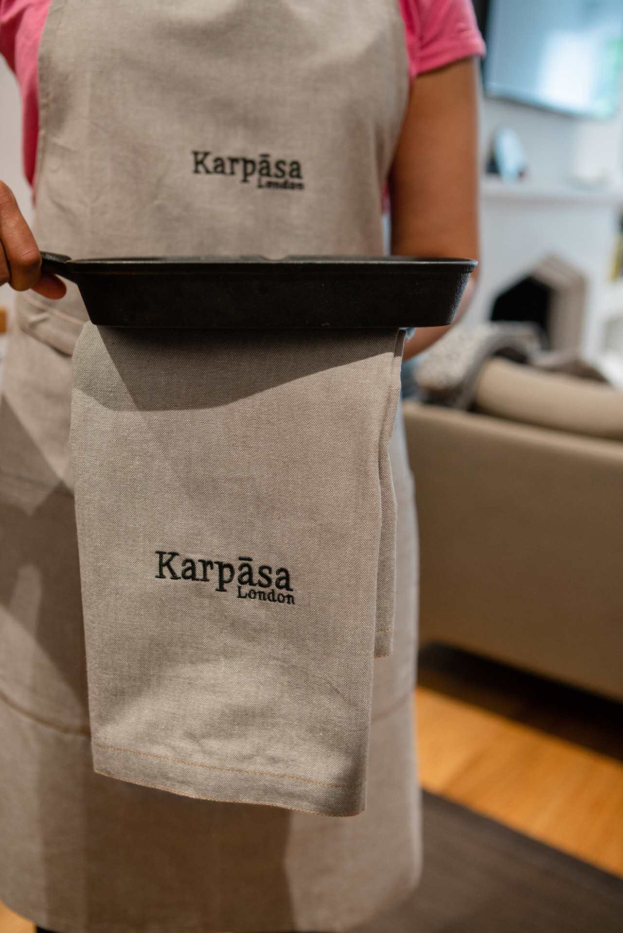 Kitchen Towel Grey - Pack of 2 - Organic Cotton seen in use with a holder in hand, showcasing Karpasa London branding.