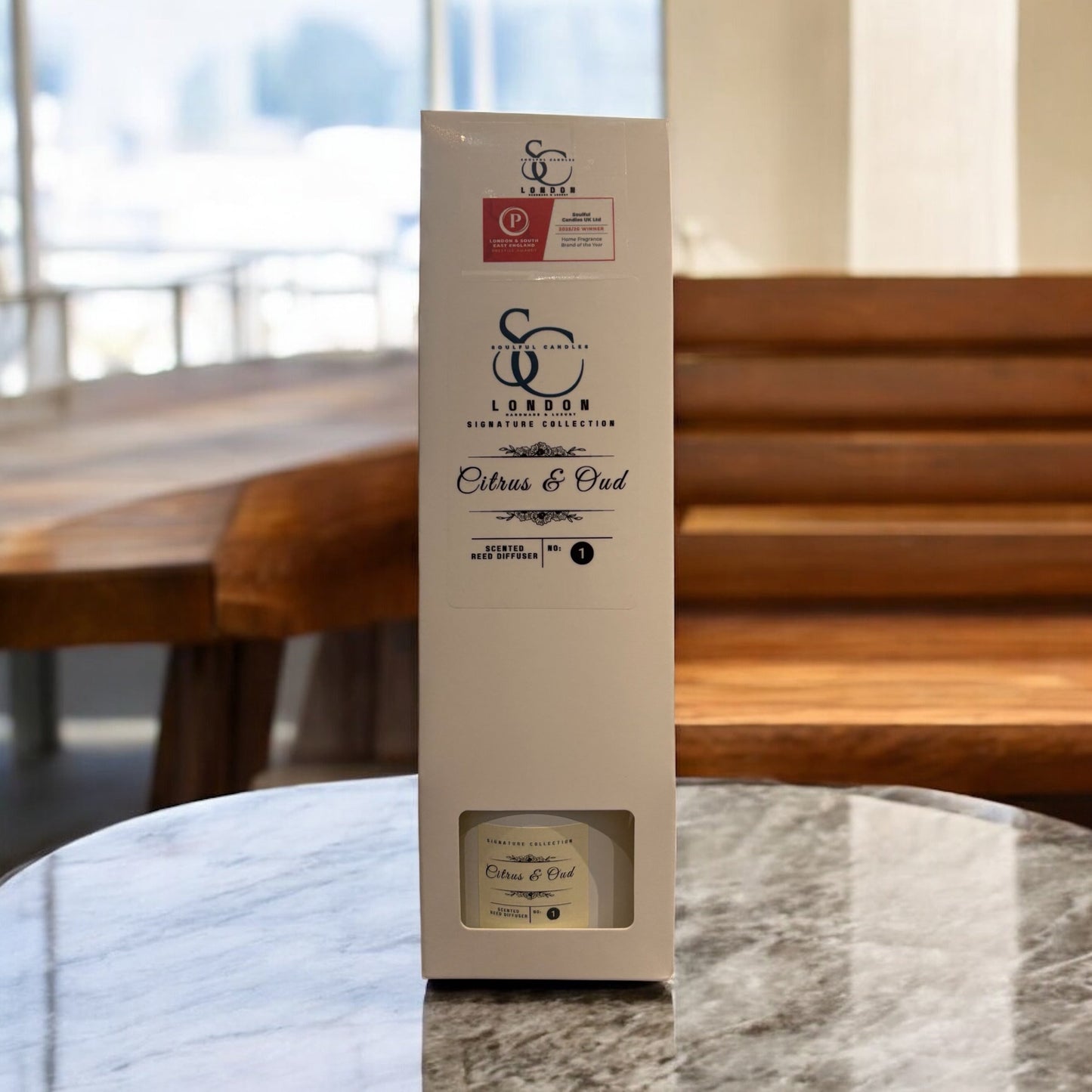 Citrus & Oud Reed Diffuser 100ml in stylish packaging displayed on a marble table.