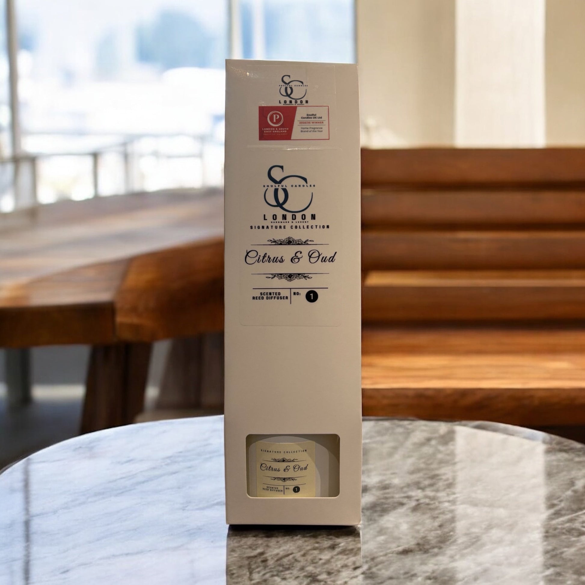 Citrus & Oud Reed Diffuser 100ml in stylish packaging displayed on a marble table.