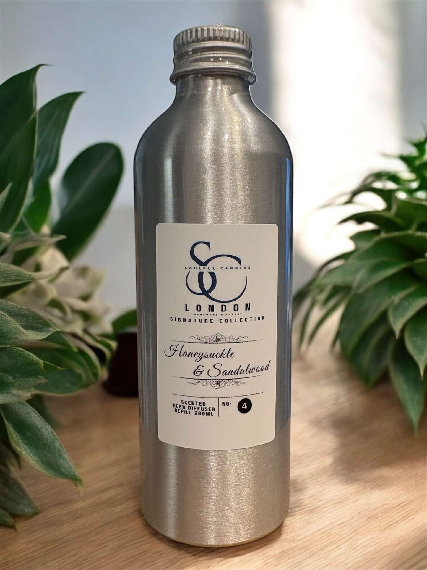 200ml Diffuser Refills Long-Lasting Luxury Home Fragrances in a silver bottle with Honeysuckle & Sandalwood label.