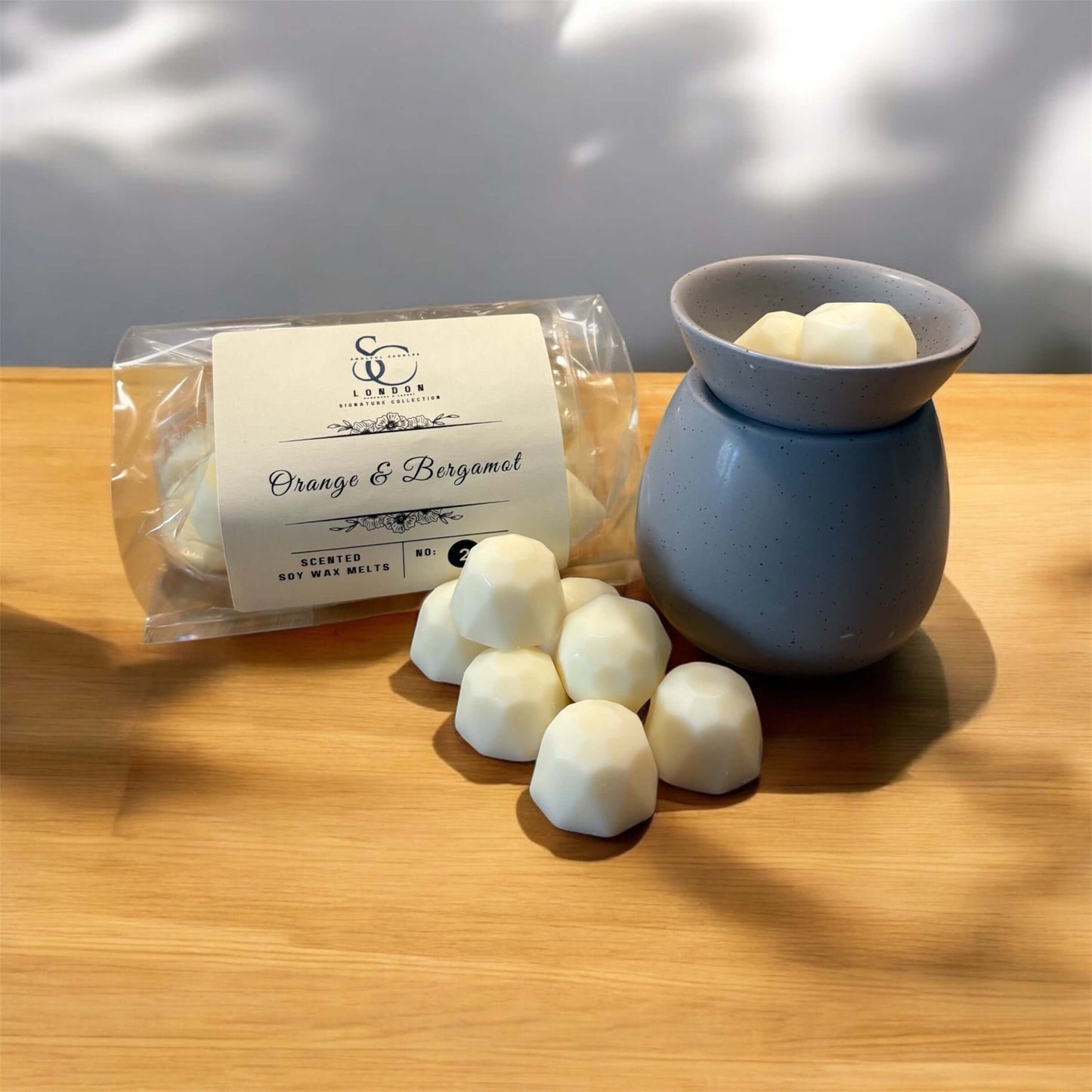 Luxury Signature Soy Wax Melts 250g in a package with orange and bergamot fragrance and a ceramic melt warmer.