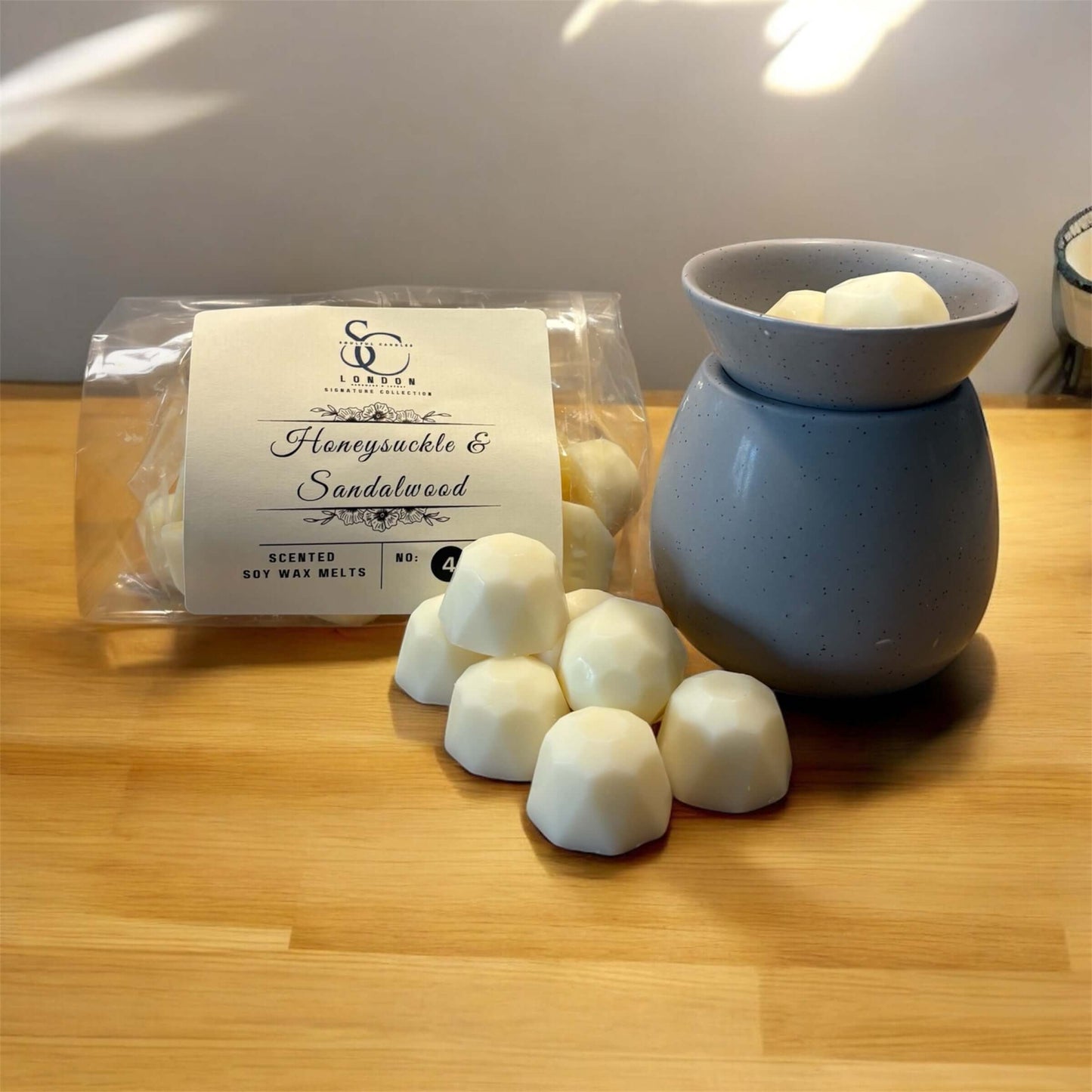 Luxury Signature Soy Wax Melts 250g in a cozy setting with Honeysuckle & Sandalwood fragrance.