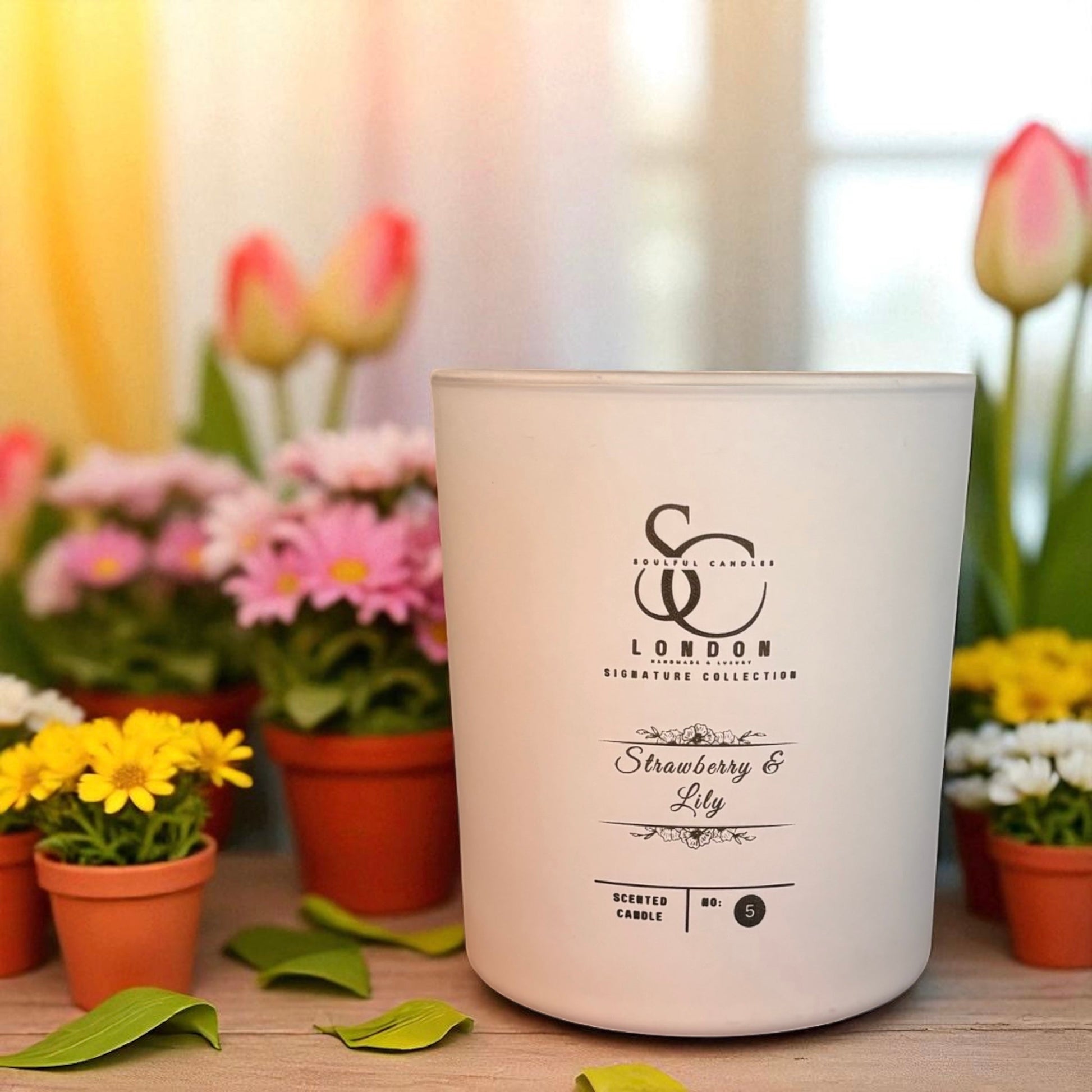 lStrawberry & Lily A fresh and delicate combination scented candle surrounded by colorful flowers.
