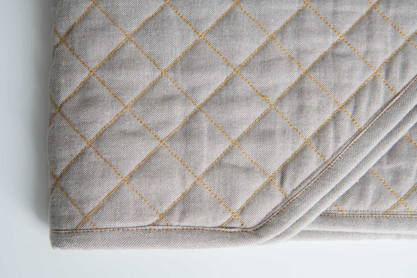 Quilted Table Runner - Organic Cotton close-up featuring luxurious chambray weave and quilted design.