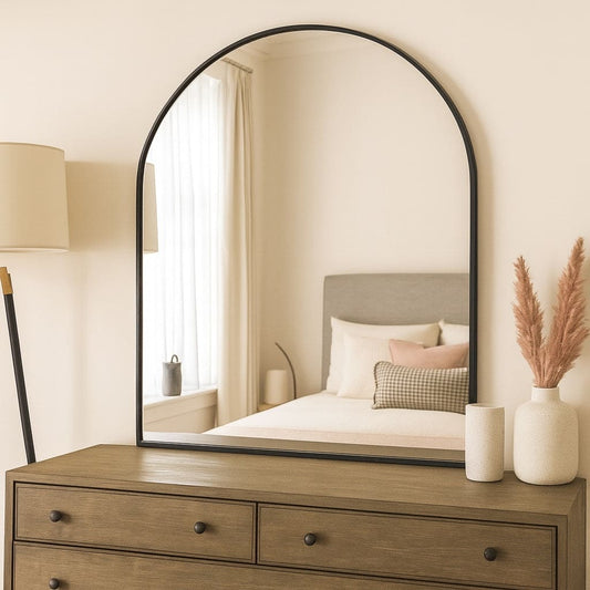Akiko - Black Metal Arched Mirror - 120cm x 95cm displayed above a dresser in a modern bedroom setting.