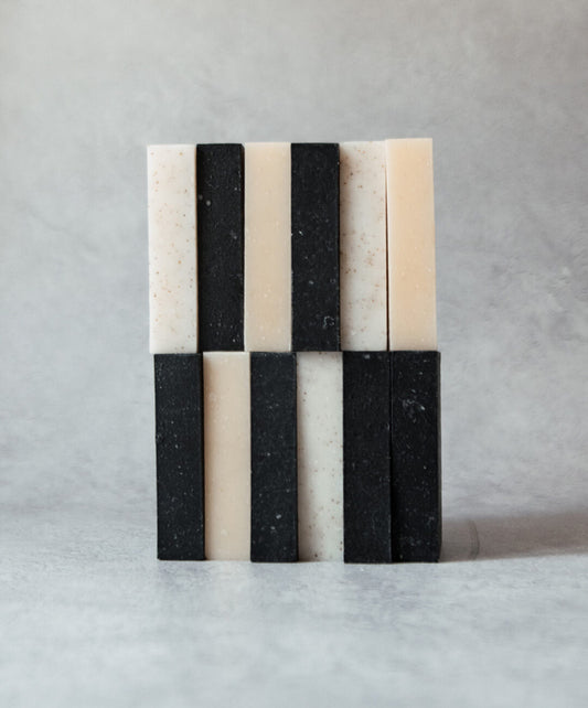 Natural Soap Bar Bundle 12 pack, featuring handcrafted soap bars in a unique black and white design.