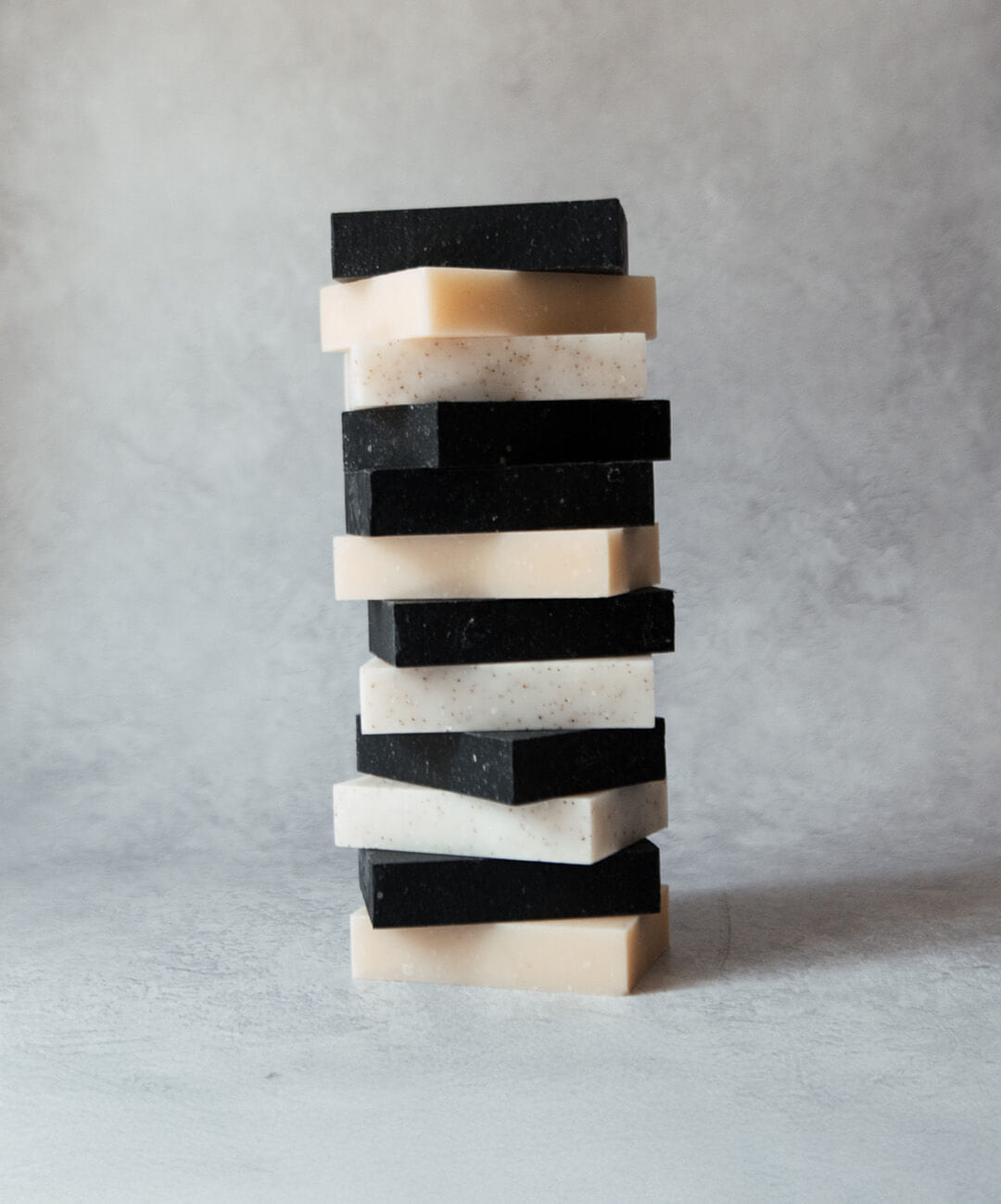 Natural Soap Bar Bundle 12 pack featuring a stacked display of premium handcrafted soap bars in various colors.