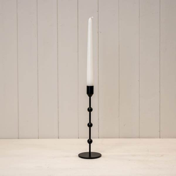 Large Black Metal Single Candle Stick displaying a tall white candle in a modern design.