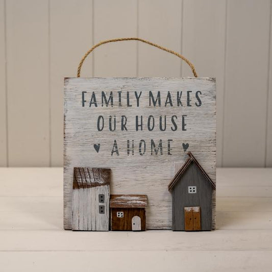 White Wooden Home Sign 'Family Makes Our House A Home' With Grey, White and Brown Stand Out Houses