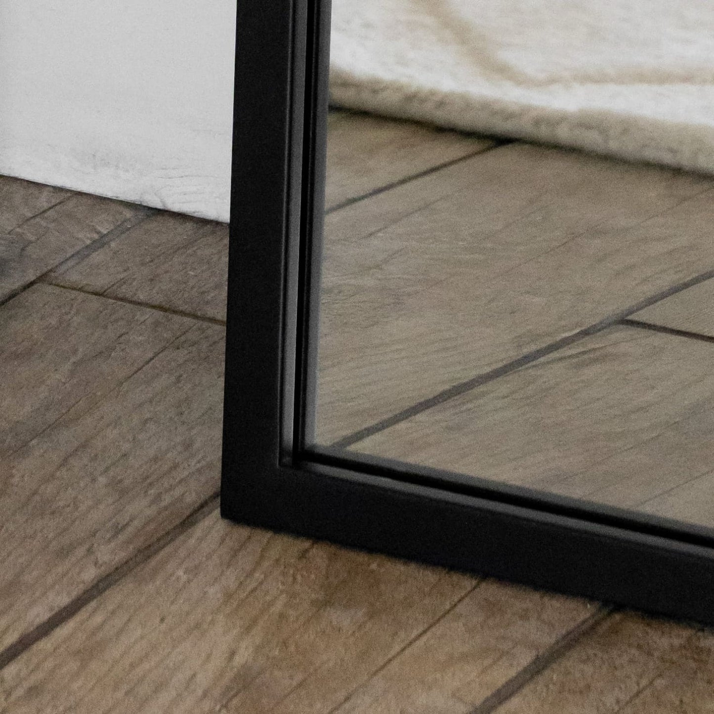 Close-up of the Yoko - Black Metal Gentle Arch Mirror - 120cm x 95cm showcasing the sleek black frame.