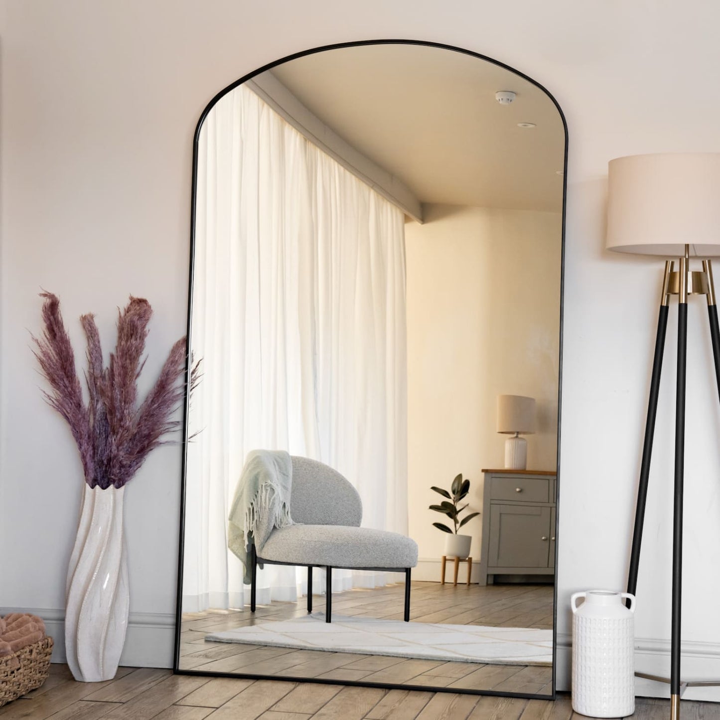 Yoko - Black Metal Gentle Arch Mirror - 180cm x 105cm elegantly displayed in a stylish interior with soft lighting.