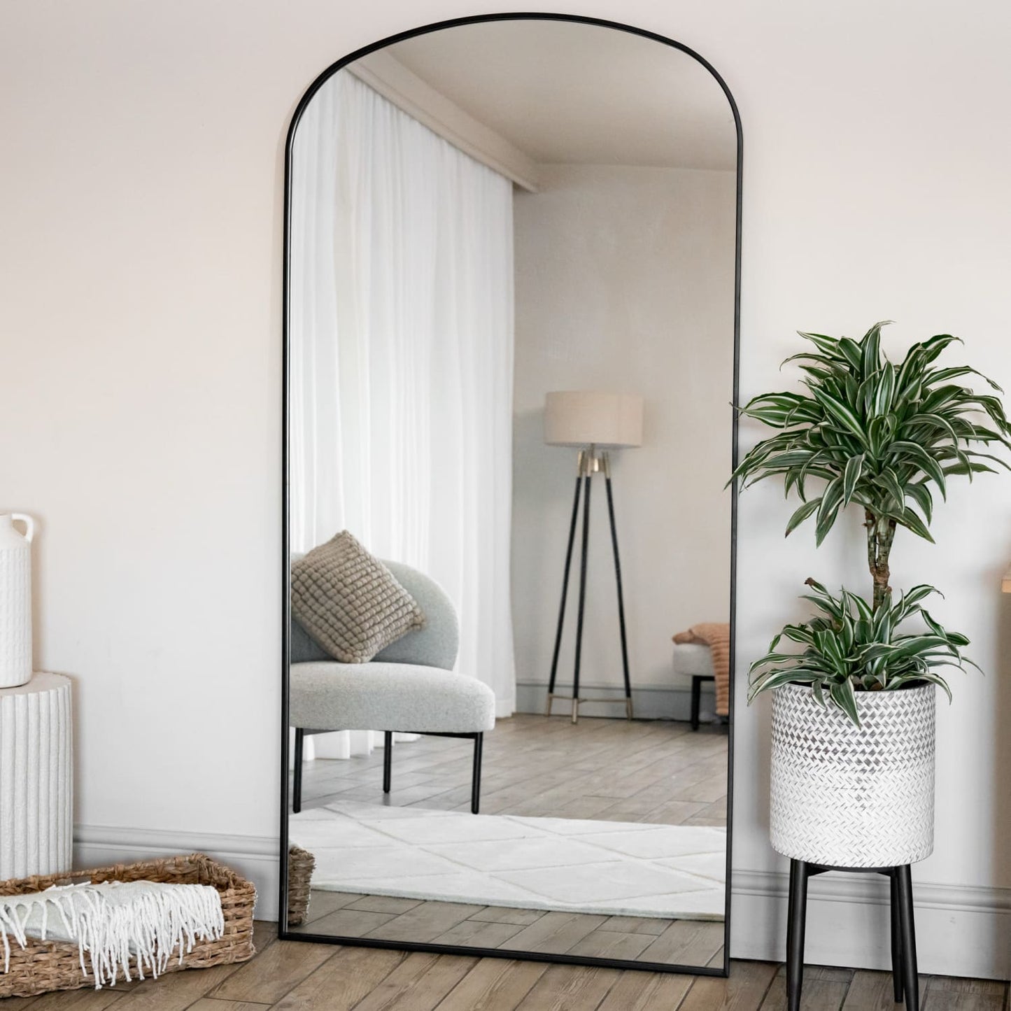 Yoko - Full Length Black Metal Gentle Arch Mirror - 180cm x 90cm reflecting stylish interior with green plant.