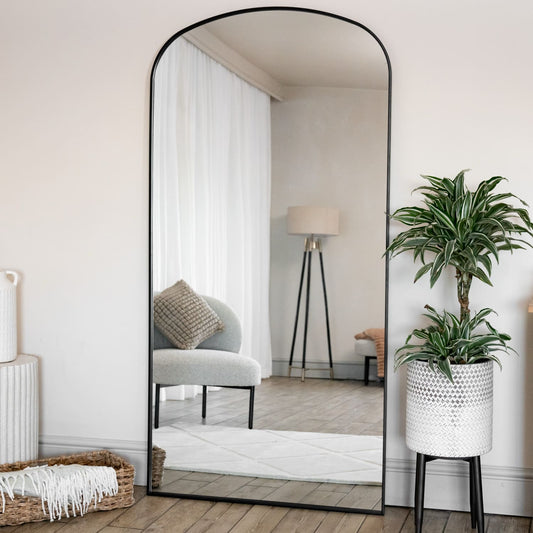 Yoko - Full Length Black Metal Gentle Arch Mirror - 180cm x 90cm reflecting stylish interior with green plant.
